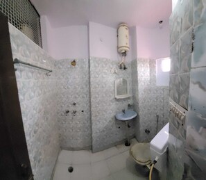 Bathroom features a sink, mirror, toilet, and shower with a glass enclosure.