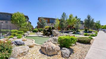 Un jardín ajardinado con rocas, arbustos y un sendero.