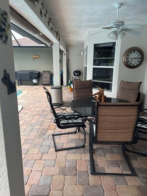 Relax in this inviting patio area with a round table and four comfortable chairs.