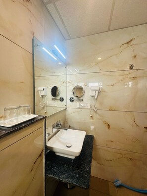 Bathroom features a modern design with a clean layout, including a vanity, sink, and two mirrors.