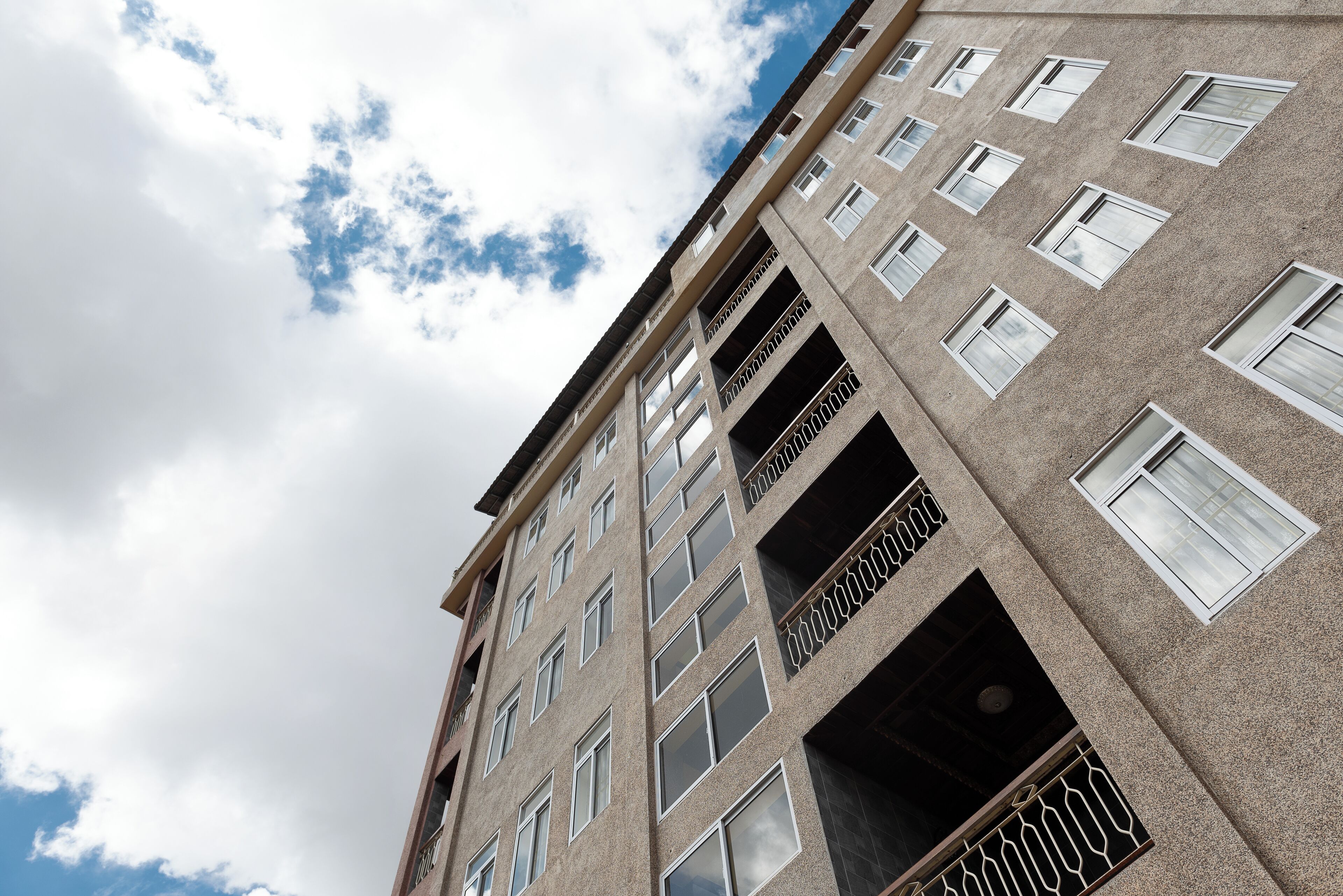 A multi-story building with balconies and windows.