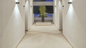 A modern building with a central open space and a view of the sky. - Seasalt Luxury Villas (Pefkochori)