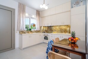 Apartment, 2 Bedrooms, Patio | Private kitchen | Full-size fridge, oven, stovetop, coffee/tea maker - Sueño Seaside Residence (Agia Pelagia)