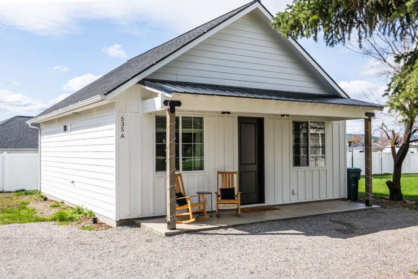 A single-story house with a covered porch, a black door, and a number '535 A' on the side.
