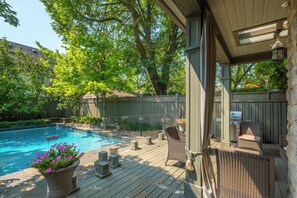 A wooden deck with a pool, wicker furniture, and a barbecue grill. - YOUR OASIS IN THE CITY (Toronto)