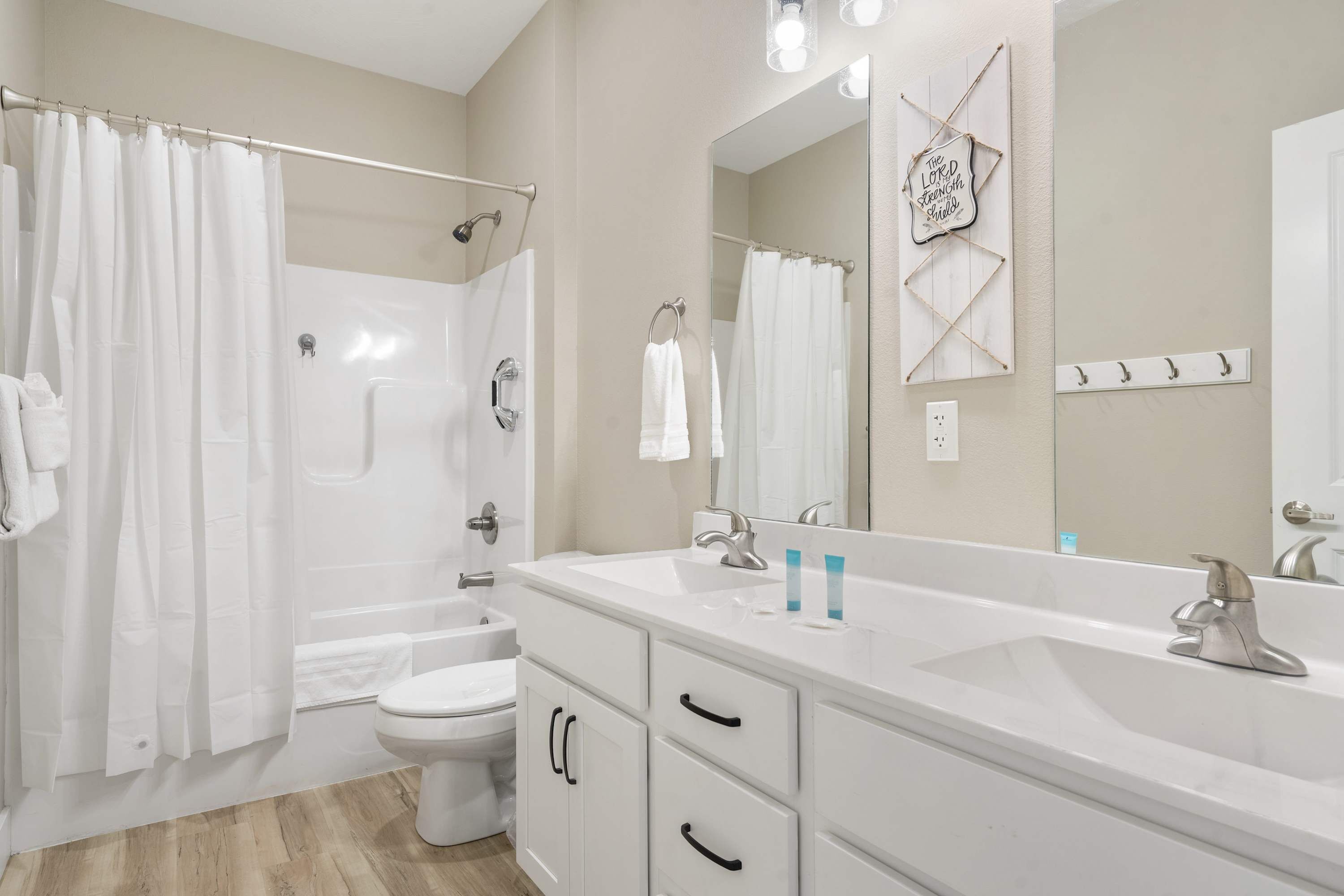 A bathroom with a bathtub, toilet, and sink.