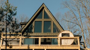 A multi-story building with a prominent triangular roof and large windows.