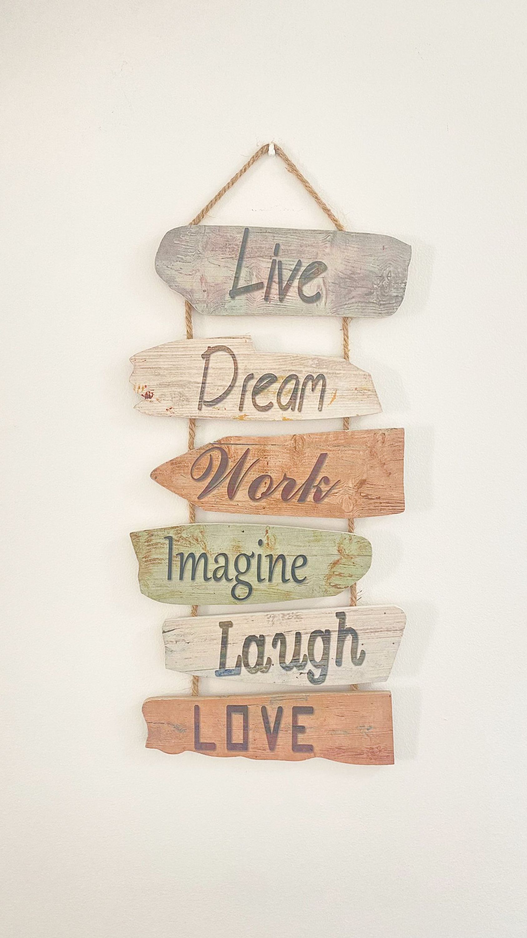 A wooden sign with motivational phrases.