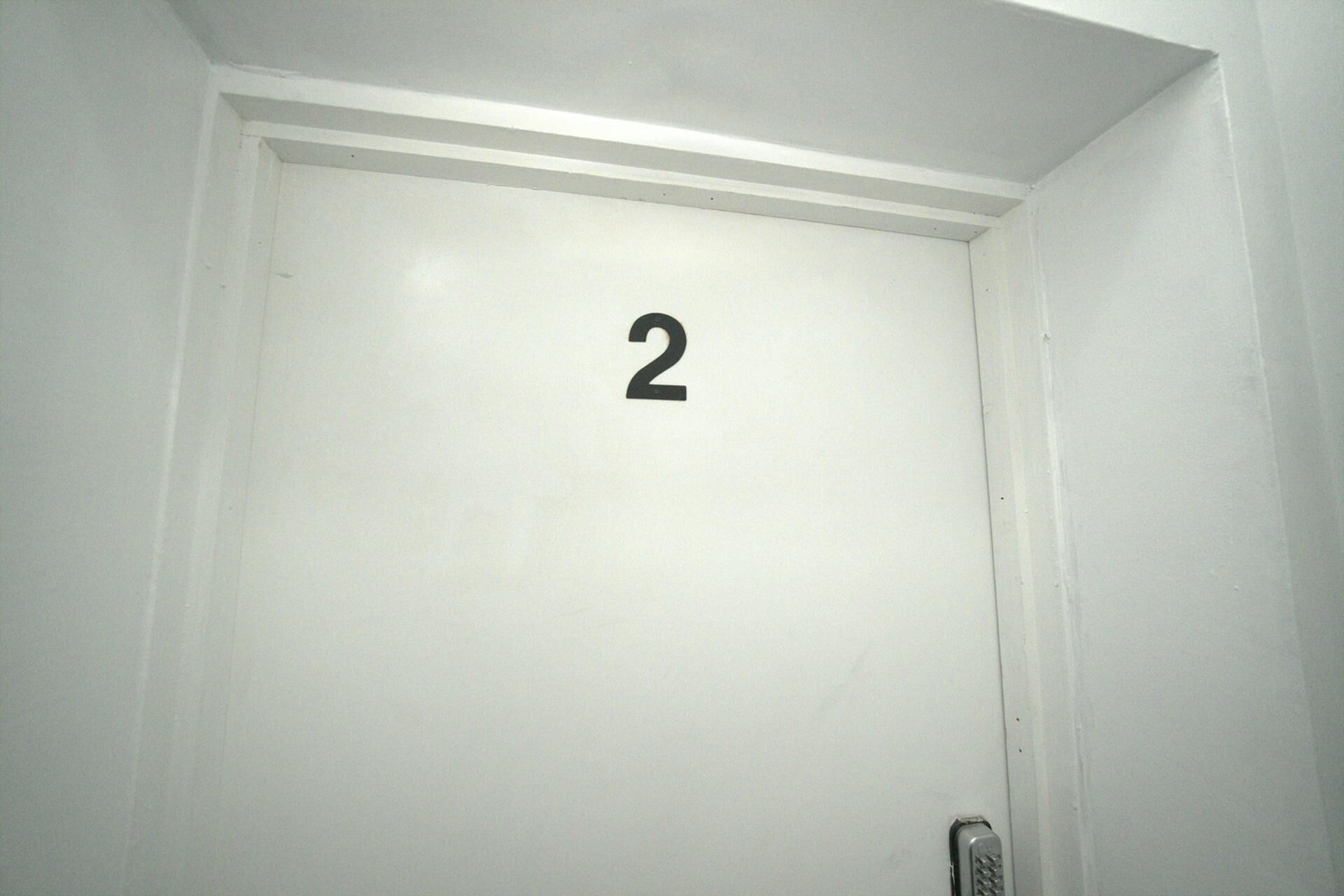 A white door with the number 2 on it.