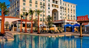 Relax by the hotel's large swimming pool surrounded by lounge chairs and umbrellas.