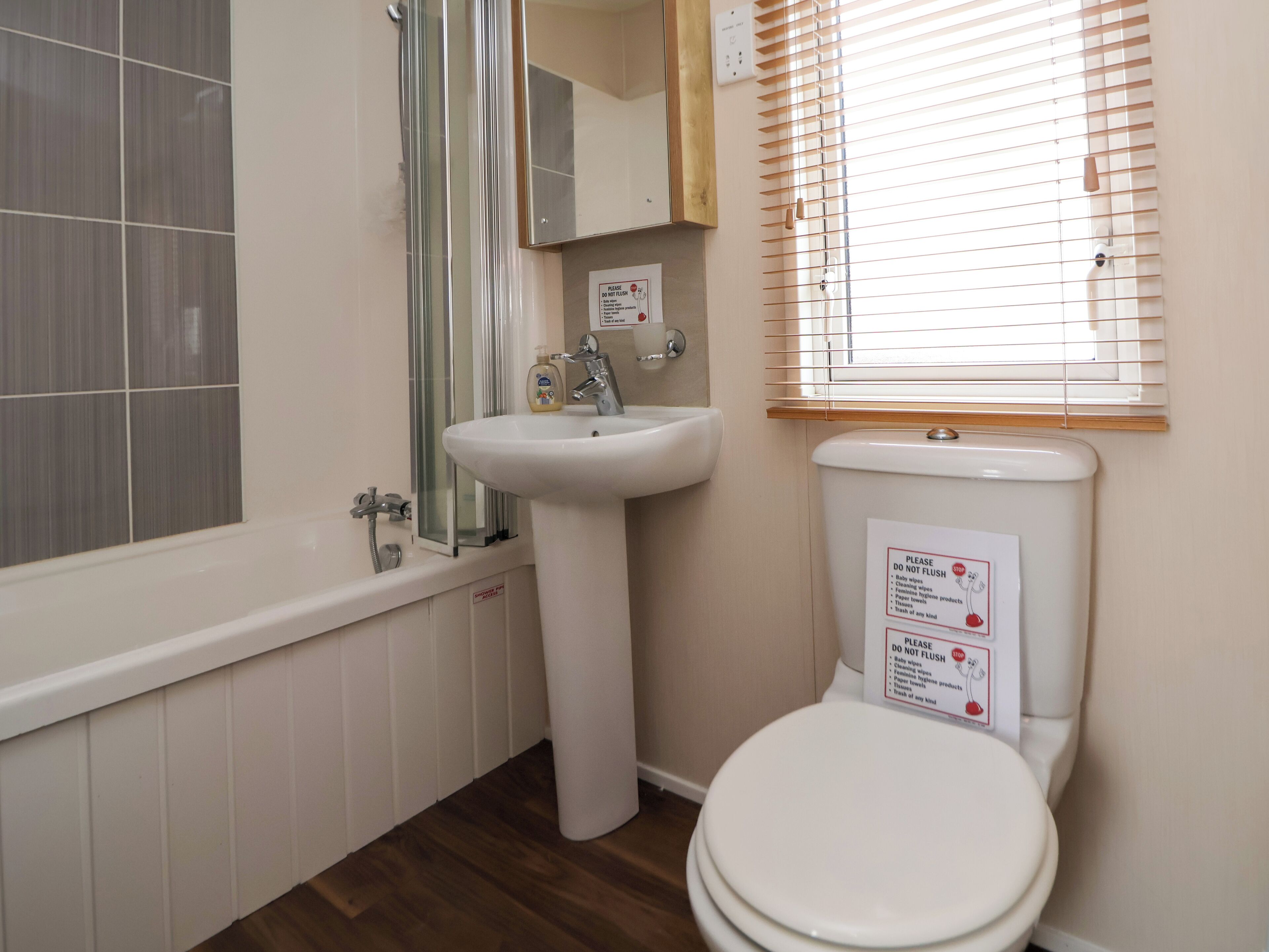 A bathroom with a bathtub, sink, and toilet.