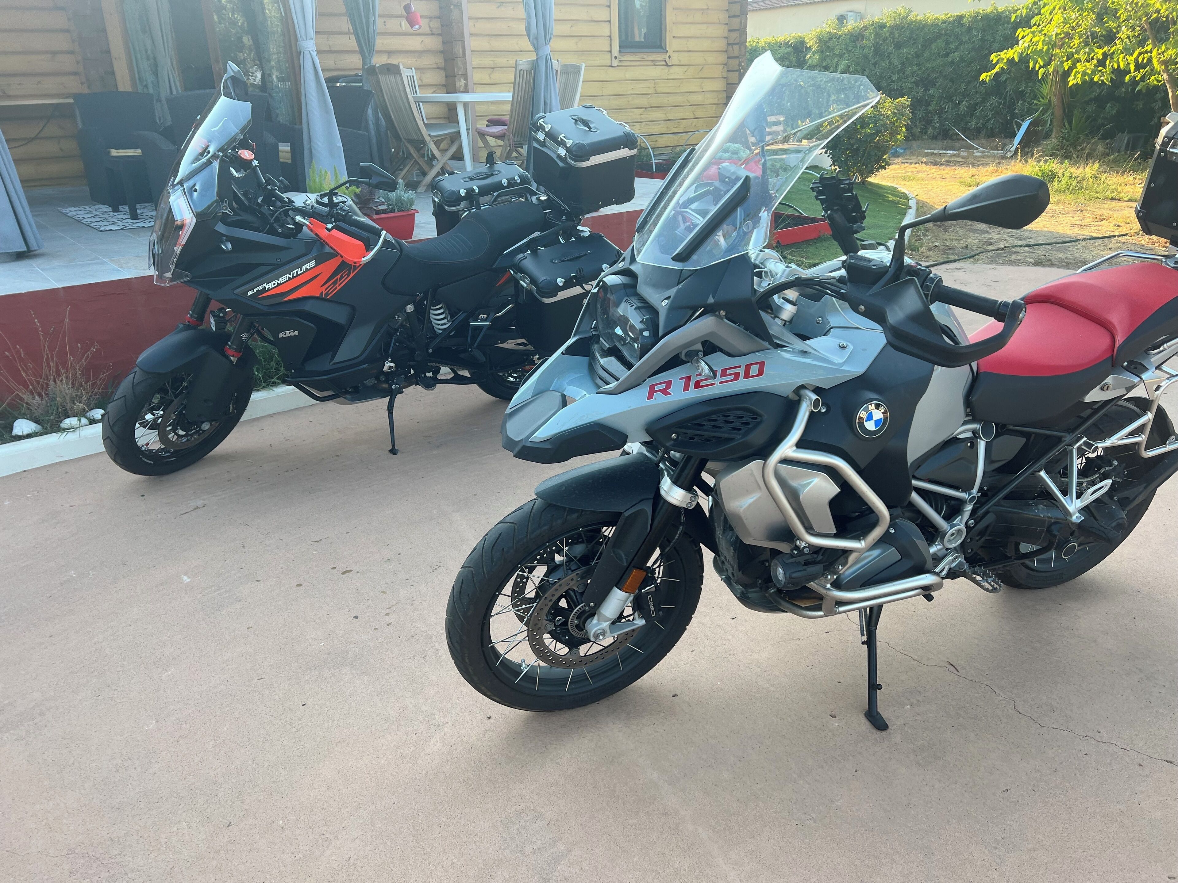 Two motorcycles parked in a driveway.