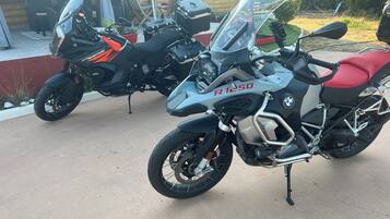 Two motorcycles parked in a driveway.