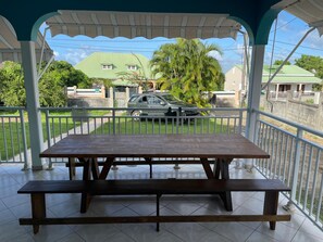 Enjoy a meal at this outdoor dining area with a picnic table and clear views of the surrounding neighborhood.