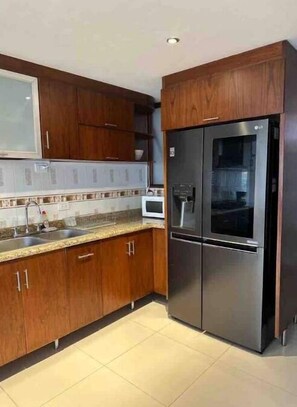 Fridge, coffee/tea maker, cookware/dishes/utensils