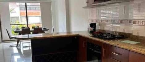 Fridge, coffee/tea maker, cookware/dishes/utensils