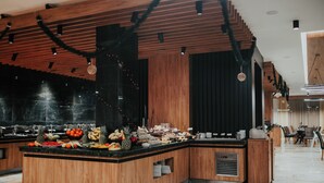 A buffet area with a wooden counter and a variety of food items. - Sante SPA Hotel (Velingrad)