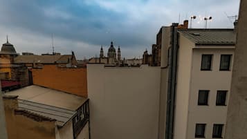 A cityscape with a prominent church dome in the distance, surrounded by various buildings with different architectural styles.