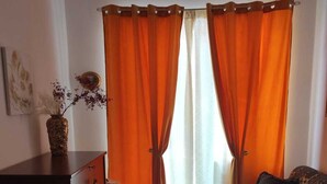 Ein Wohnzimmer mit einer Couch, einem Holzschrank und einem Teppich.