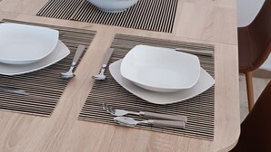 A dining table set with white plates, cutlery, and a placemat. - PAP'S HOUSE  (Rodes)