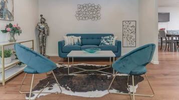 Relax in this stylish living room with a comfortable sofa, coffee table, and dining area.