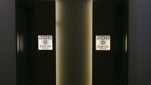 A hotel corridor with doors labeled 205 and 206, each with a 'Stay On Hotel' sign. - STAY ON HOTEL (Izmir)