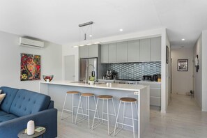 TV, fireplace - Sun and Surf Retreat - Papamoa Beach Holiday Home (Papamoa)