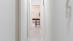 A narrow, well-lit hallway with white walls and a tiled floor. - 2-bedroom apartment - close to beaches and center (Torrevieja)