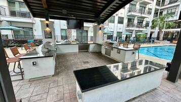 An outdoor pool area with a bar and seating.