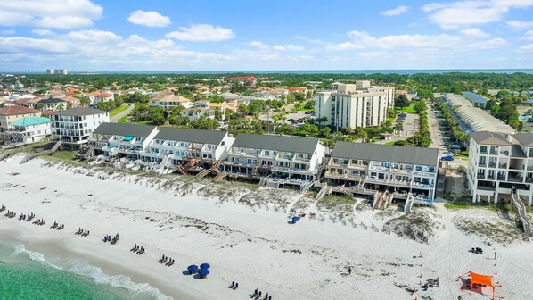A beachfront hotel with multiple buildings, a sandy beach, and a clear view of the ocean. - Green Reef #8- Beachy Keen (Destin)