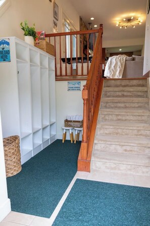 A staircase with a wooden handrail leading to a landing.
