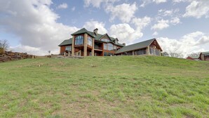 A large, multi-story house with a prominent front porch and large windows. - 366 Shared Acres, Lake Access: Ozark Getaway! (Shirley)