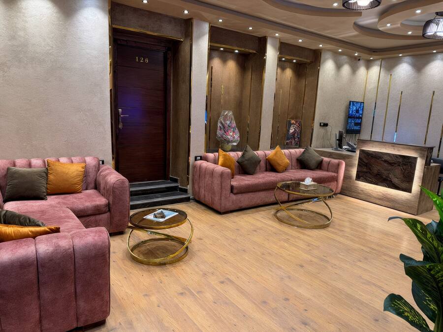 Un moderno vestíbulo con asientos mullidos, un mostrador de recepción y una zona de recepción de madera.
