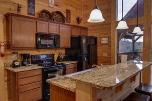 Fridge, dishwasher, coffee/tea maker, cookware/dishes/utensils