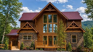 A log cabin with a stone facade, large windows, and a red roof. - Cabin + FREE Resort Amenities | Pigeon Forge (Pigeon Forge)