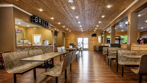 A restaurant with wooden ceiling, tables, and benches. - Cabin + FREE Resort Amenities | Pigeon Forge (Pigeon Forge)