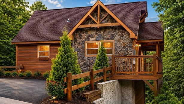 A log cabin with a stone facade, wooden deck, and a stone staircase leading to a porch. - Near Dollywood + Resort Amenities Included (Pigeon Forge)