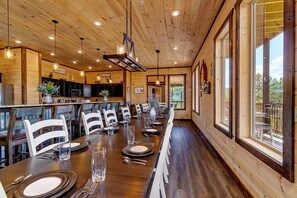 Enjoy meals in this dining area with a long table and comfortable seating for all.
