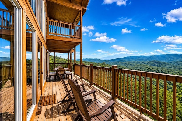 A wooden deck with a view of a mountainous landscape.