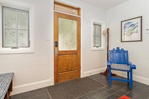 A hallway with a wooden door, a blue bench, and a framed picture on the wall. - South Oak Retreat - convenient luxury by gondola! (Telluride)