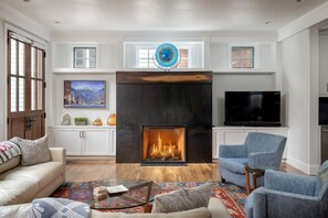 A living room with a fireplace, a television, and seating. - South Oak Retreat - convenient luxury by gondola! (Telluride)