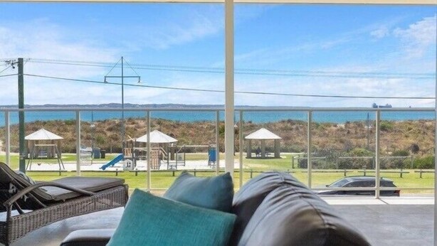 A balcony with a view of a beach and playground. - Coastal Vibes with a touch of convenience (Rockingham)
