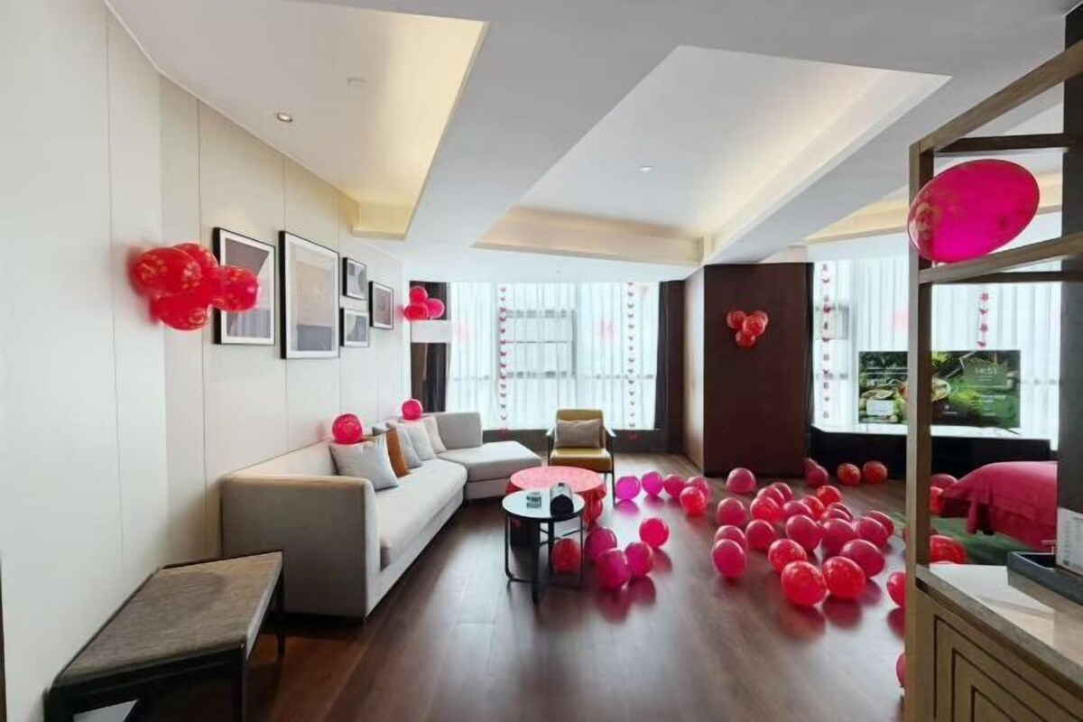 A modern living room with a sofa, coffee table, and decorative elements.