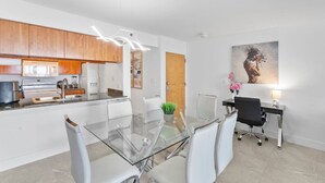 A modern kitchen with wooden cabinets, a built-in microwave, and a stainless steel sink.