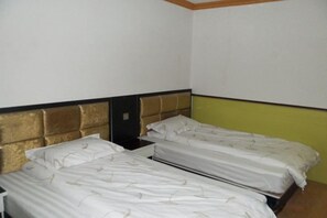 A room with two single beds, a nightstand, and a wall-mounted shelf. - Jinshang Hostel (Shanghai)
