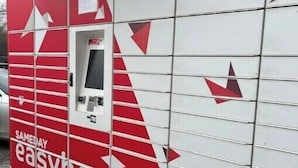 A red and white easybox with a vending machine and a window.