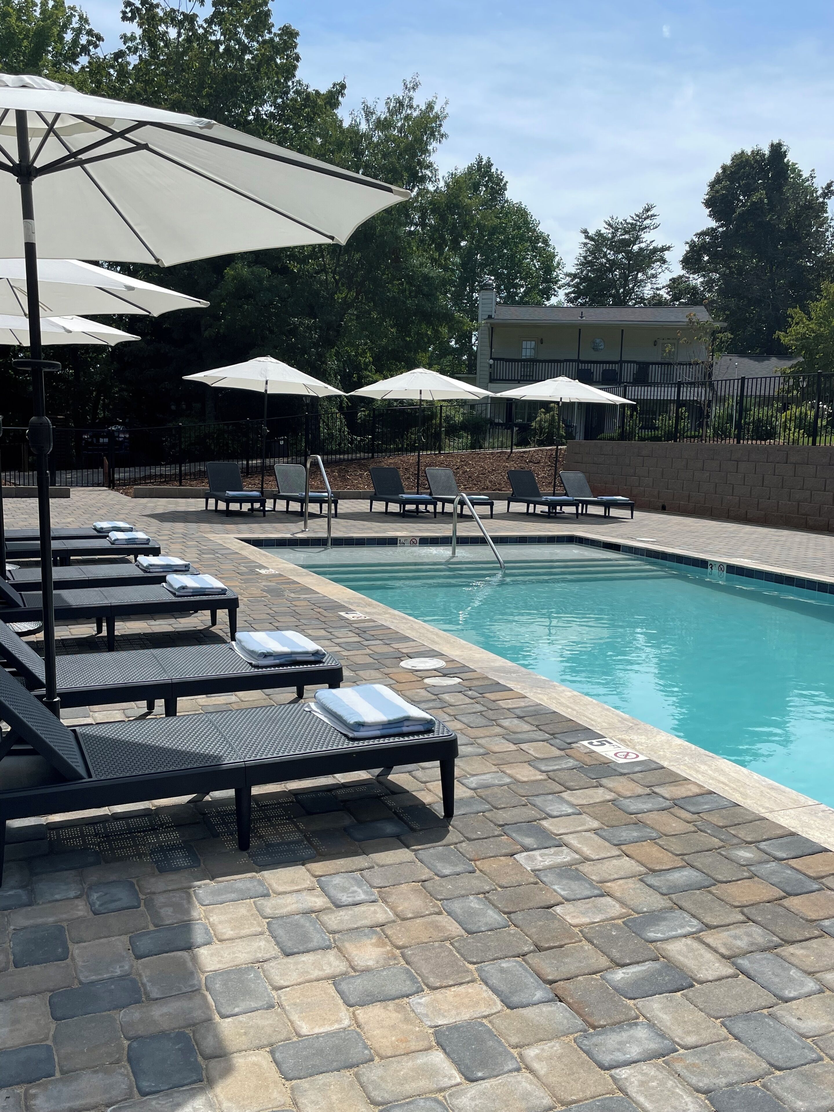 Outdoor pool, open 9:00 AM to 8:00 PM, pool umbrellas, pool loungers