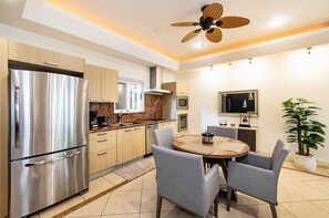 Enjoy cooking in this well-equipped kitchen with a refrigerator, oven, and microwave. Dine at the round table with four chairs.
