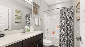 Shower, hair dryer, towels, shampoo