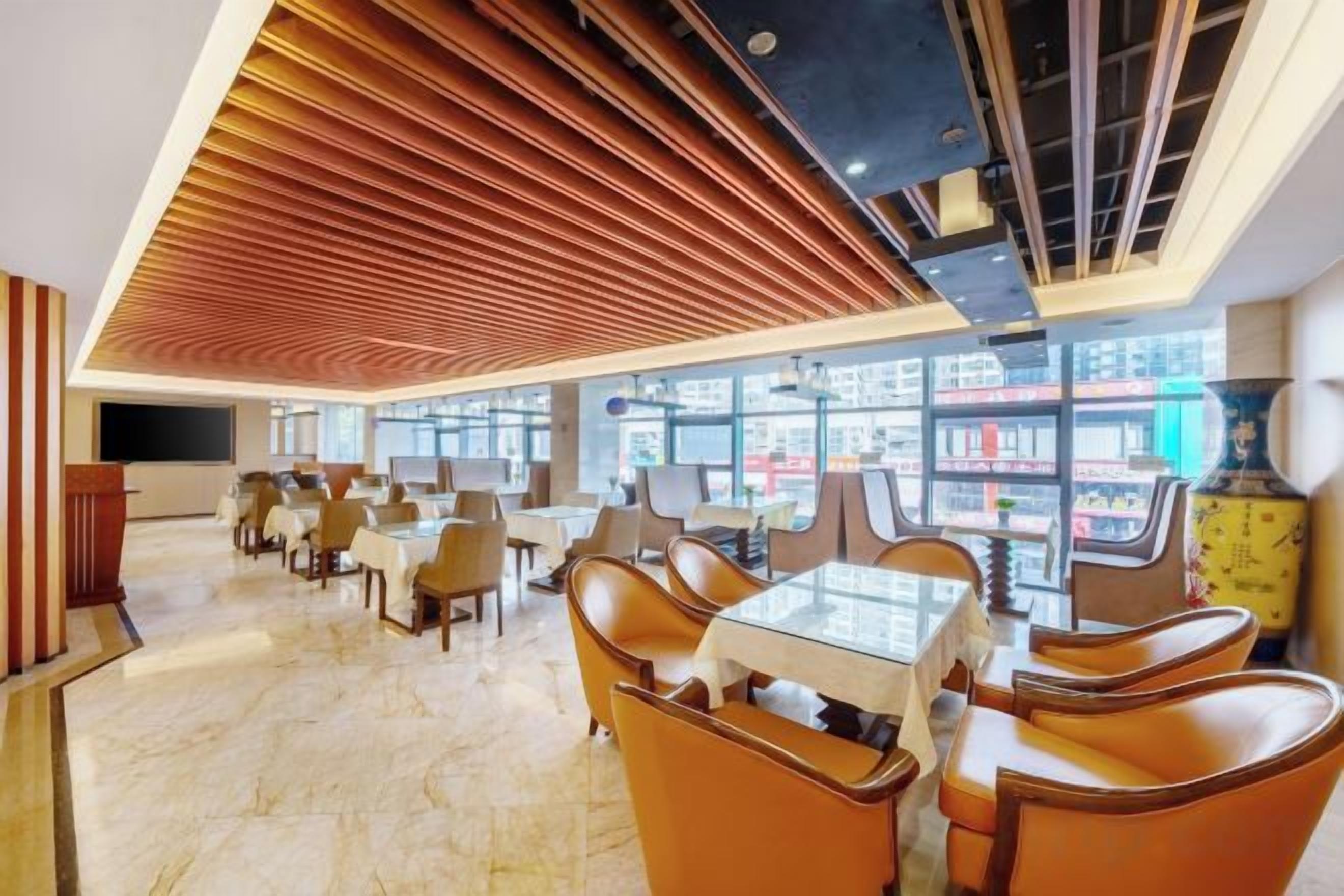 A spacious dining area with high ceilings and modern furnishings.